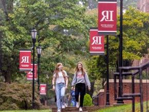 Students walking on campus with LR banners on light poles